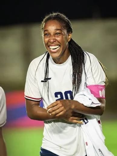 Brianne Reed smiling in a Dominican Republic soccer jersey.