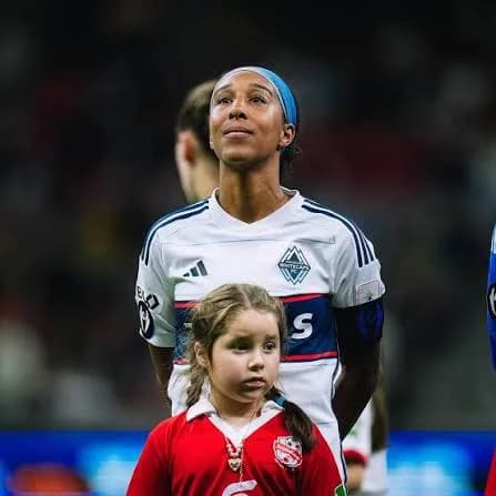 Brianne Reed standing before kickoff in a white club jersey.