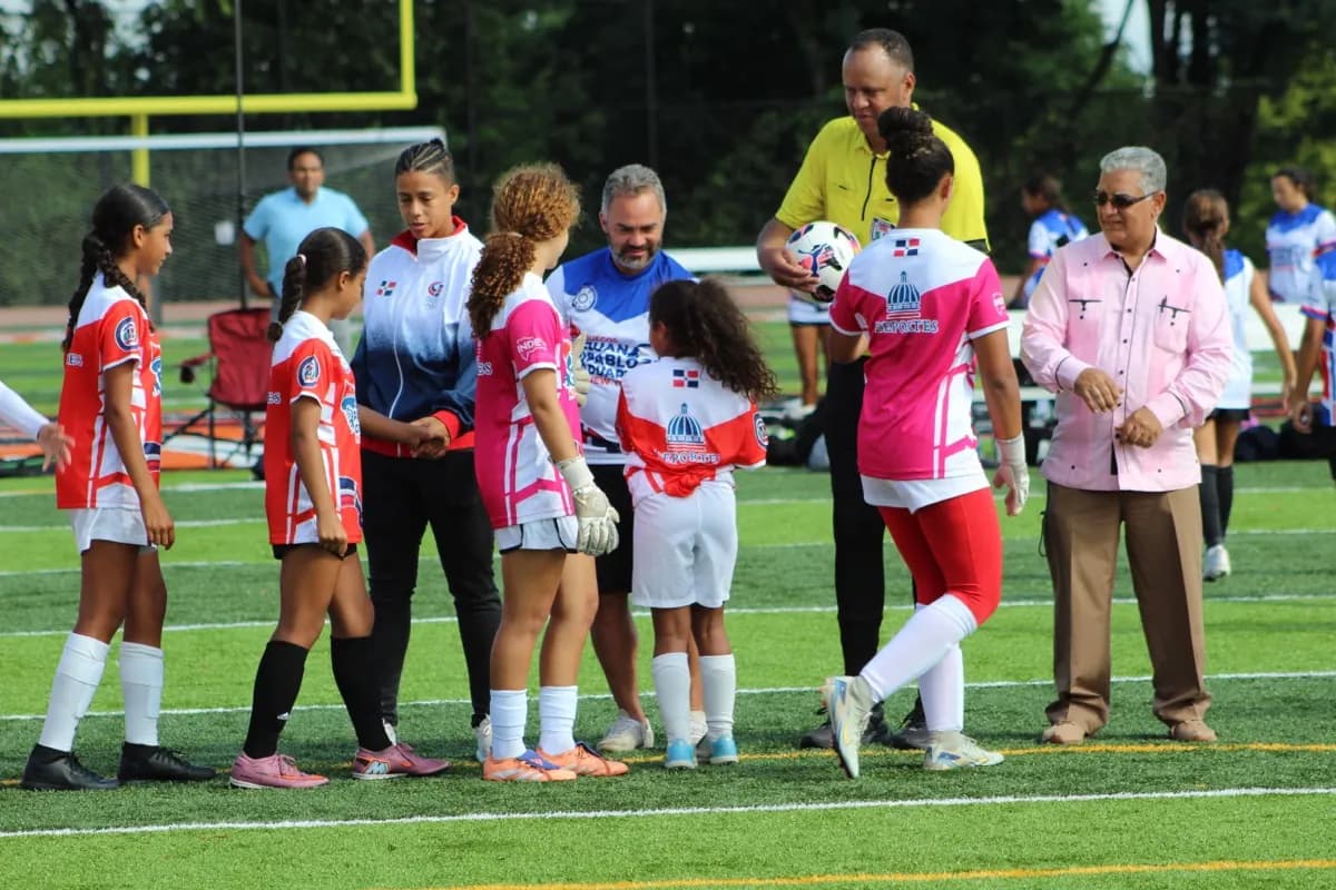 Coaches, officials, and captains meet at midfield before the match.